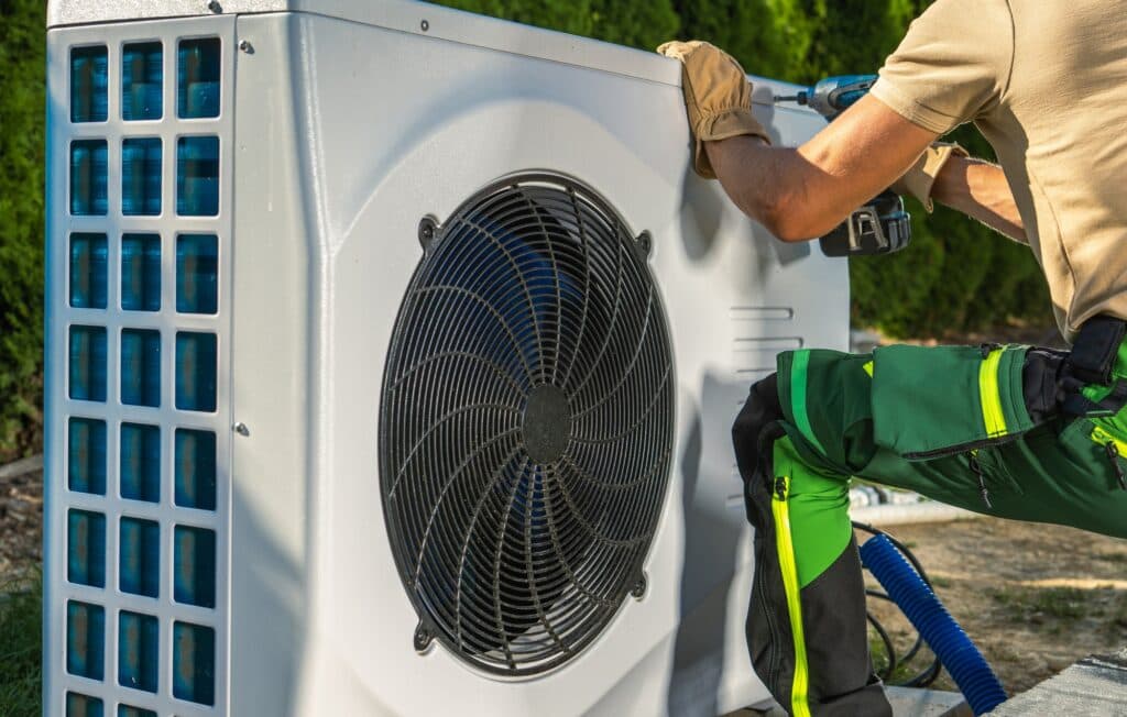 Technician installing a heat pump